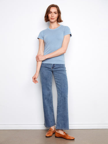 This chic blue top combines a classic crew neck with modern ribbed detailing for a fresh look. By Charlie B.