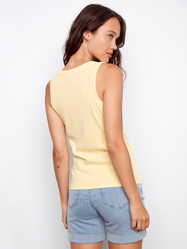 Scoop neck yellow tank top in ribbed fabric, complemented by wide straps and denim shorts for chic comfort by Charlie B.