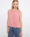 Pink sleeveless top with a loose fit, perfect for casual outings. The scallop hem adds a playful touch to this stylish piece by Charlie B.