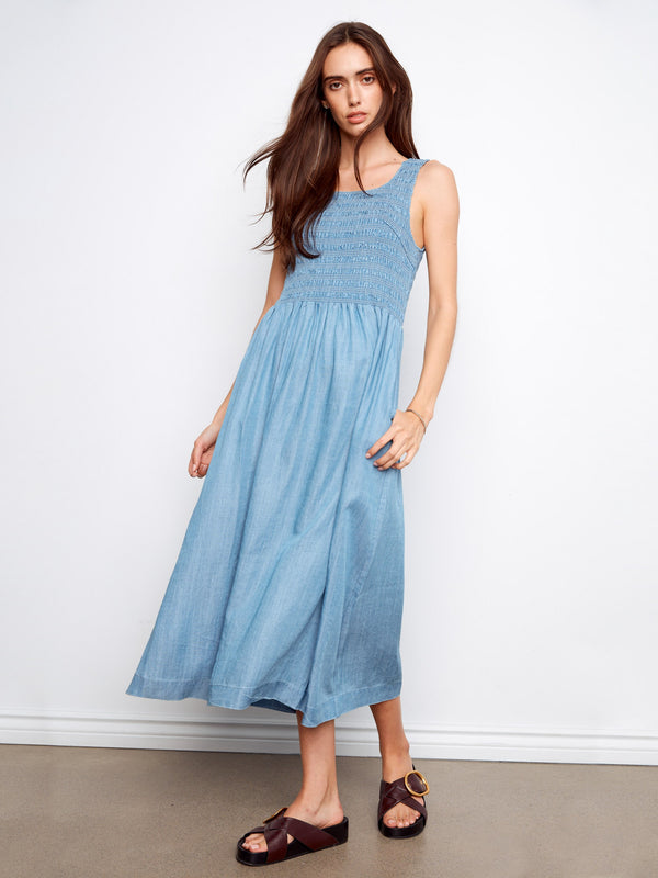 Experience comfort in this blue sleeveless maxi dress featuring a flattering scoop neckline by Charlie B.