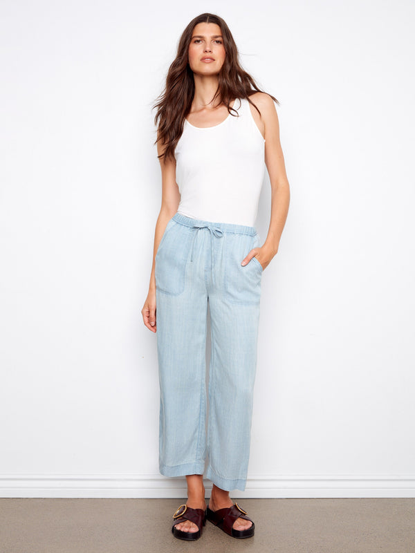 Light blue jogger pants feature a wide leg and cropped length, perfect for casual outings. Crafted from Tencel by Charlie B.