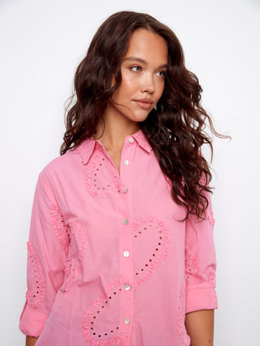 Cotton blouse in pink with adjustable roll-up sleeves and intricate eyelet patterns by Charlie B.
