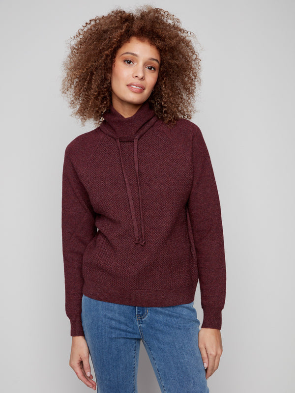 Featuring classic raglan sleeves, this Cabernet knit sweater offers both style and comfort by Charlie B.