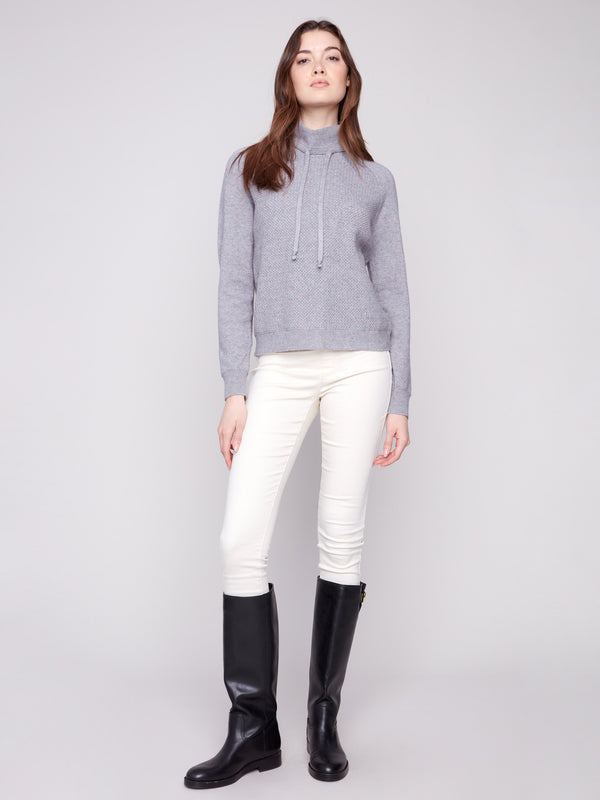 Textured front design adds a touch of sophistication to this cozy heather grey sweater by Charlie B.
