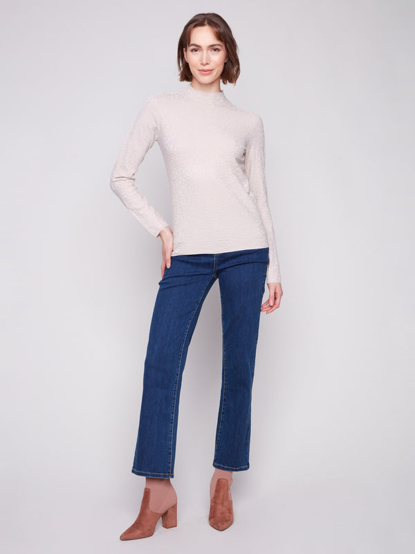 Textured oat sweater in a slim fit, styled with classic blue jeans and brown boots by Charlie B.