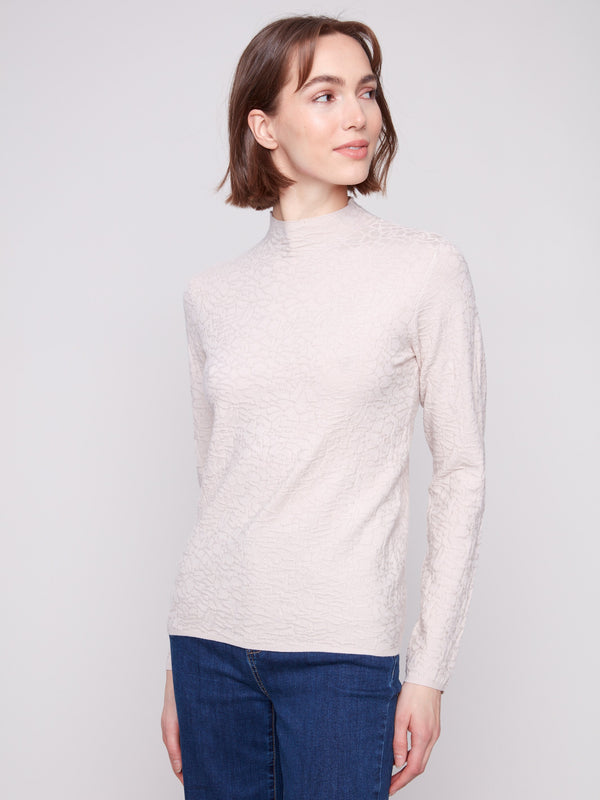 Chic oat sweater with textured fabric, matched perfectly with denim jeans for effortless style by Charlie B.