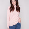 Ballet pink sweater with a mock neck and slim fit, paired perfectly with blue jeans for a chic look by Charlie B.