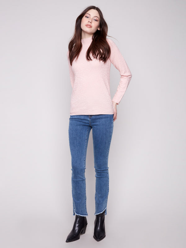 Textured ballet pink sweater offering a stylish slim fit, matched with classic blue jeans by Charlie B.
