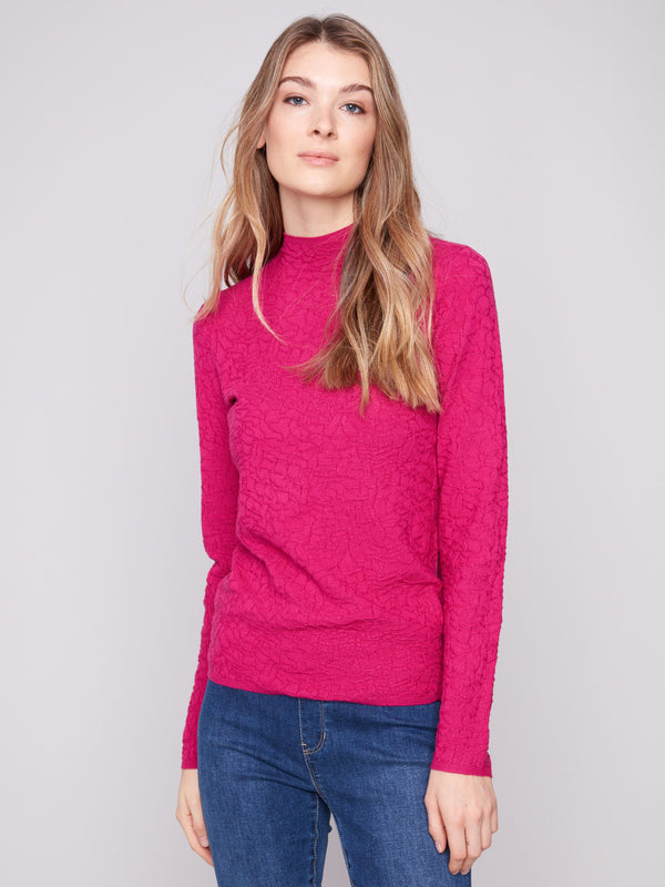 Hibiscus sweater featuring a slim fit, paired with blue jeans for a chic look by Charlie B.