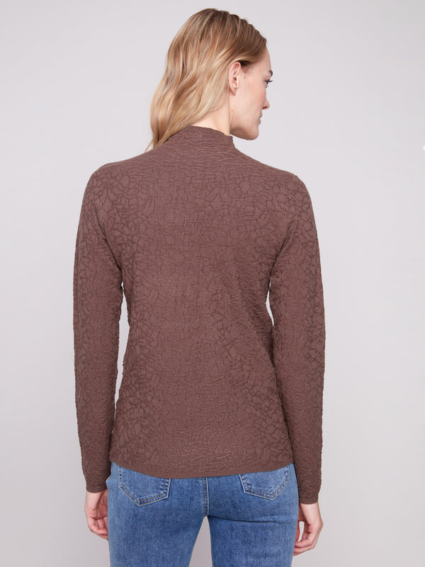 Textured mocha sweater styled with classic blue jeans, showcasing a chic and modern design by Charlie B.