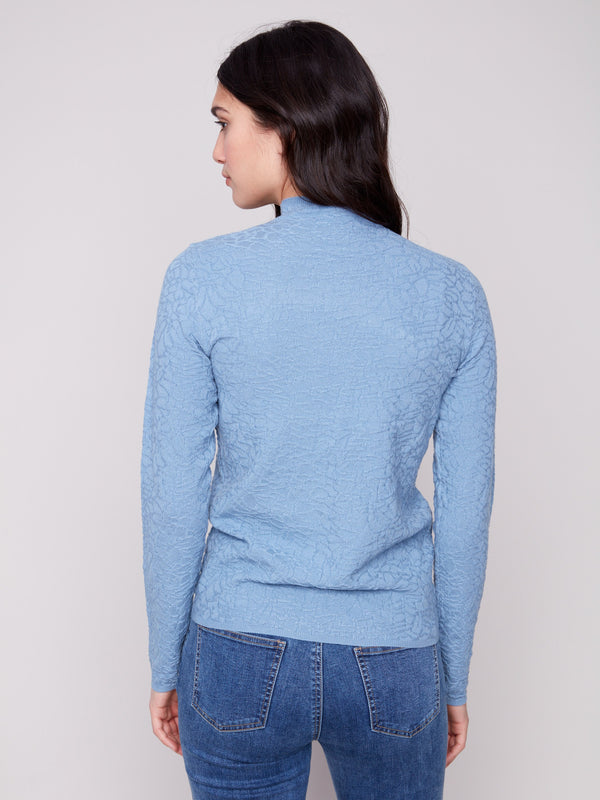 Mock neck design in an oxford blue textured sweater, matched perfectly with jeans by Charlie B.