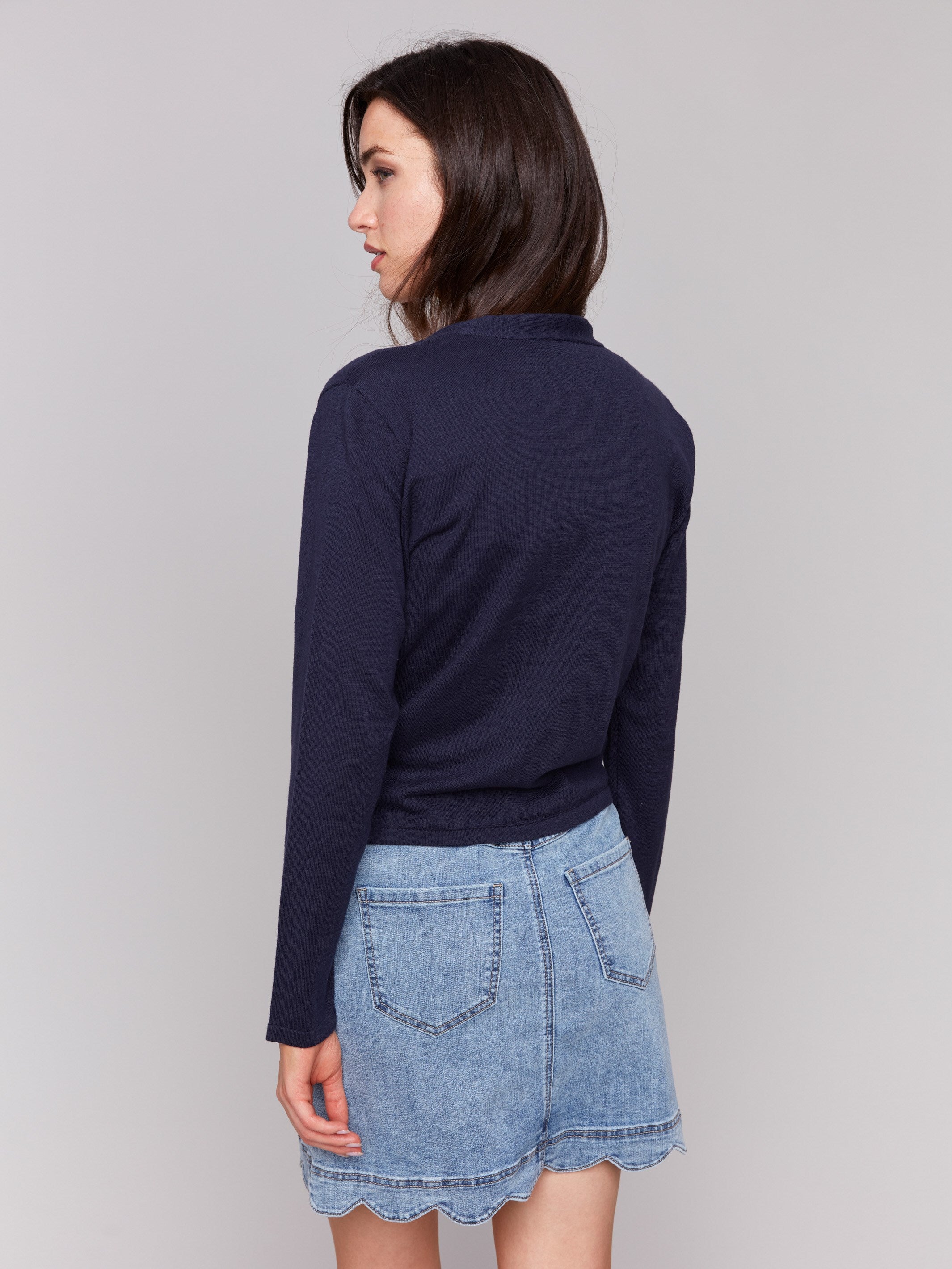 Navy bolero showcasing a stylish front tie detail by Charlie B.