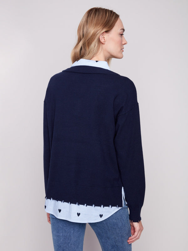 Stylish navy sweater featuring a frayed finish at the cuffs and hem, adding an edgy touch to the look by Charlie B.