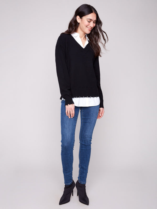 Stylish black sweater with side slits and layered look, highlighted by a poplin shirt collar by Charlie B.