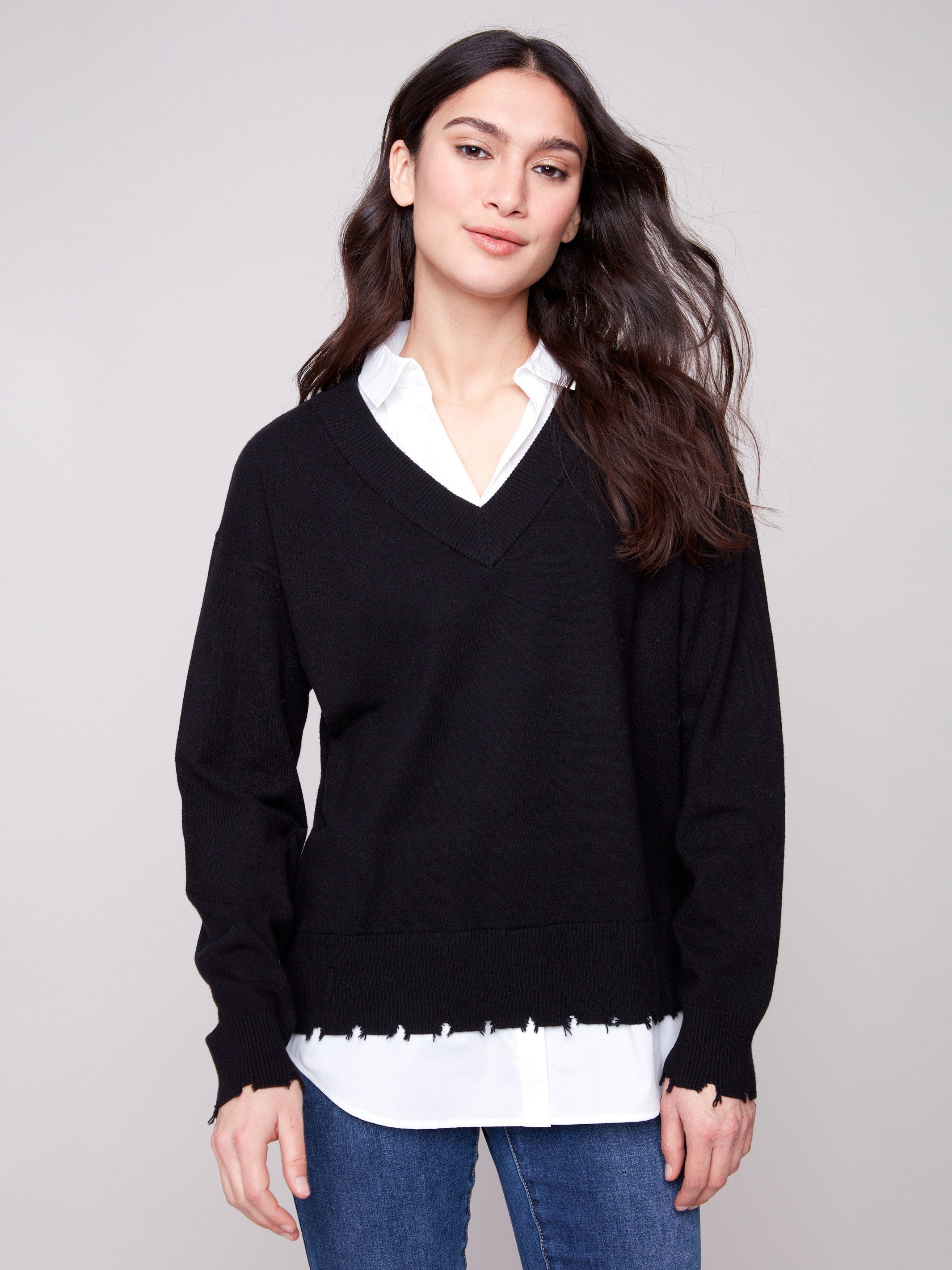 Chic black V-neck sweater adorned with long sleeves and frayed details at the hem for added style by Charlie B.