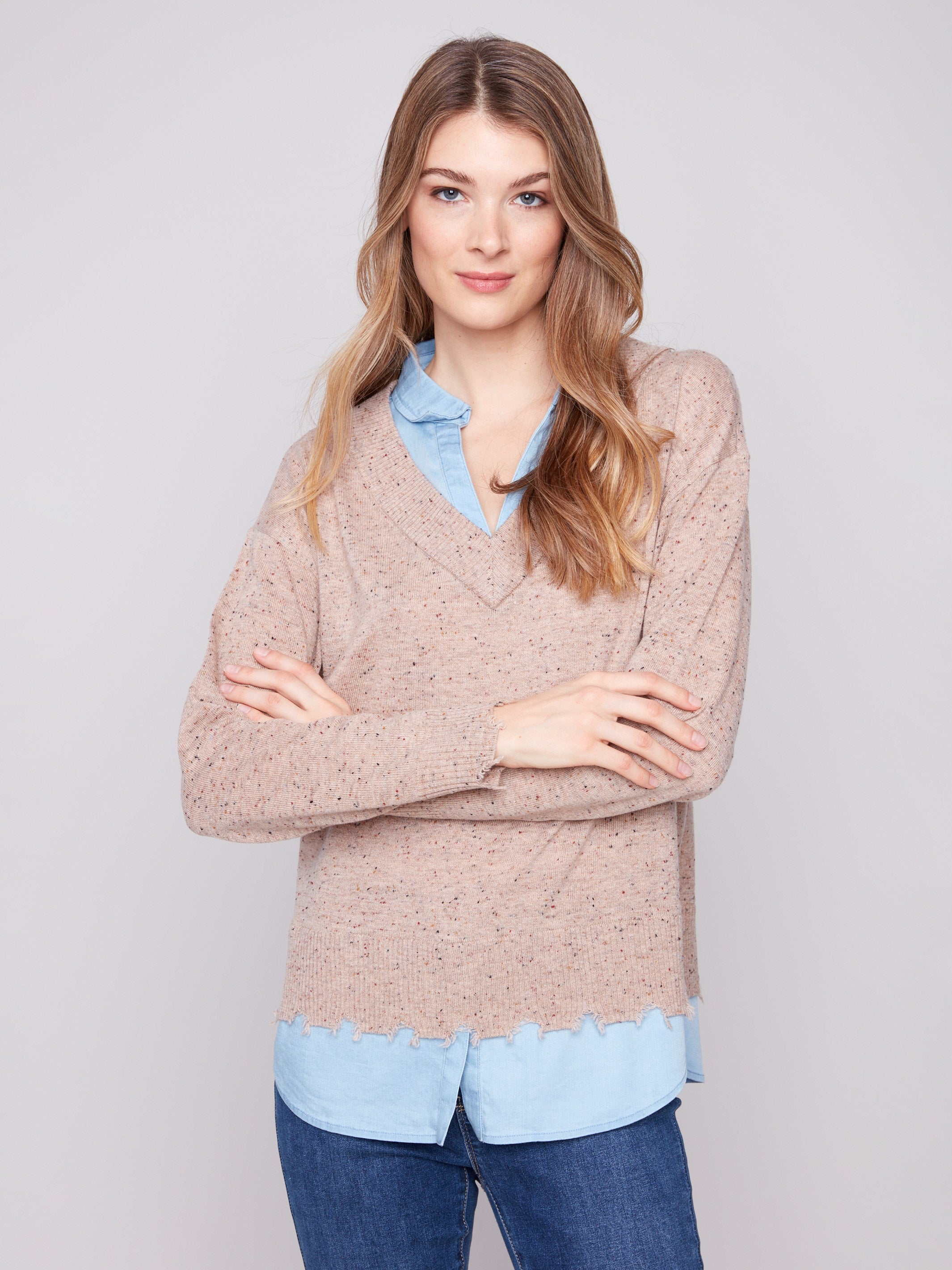 Elegant oat flecks sweater showcasing a frayed finish at cuffs and hem, adding a trendy touch by Charlie B.