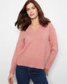 Pink sweater with a stylish V-neckline, offering a classic and elegant look. Perfect for pairing with jeans or skirts. By Charlie B.