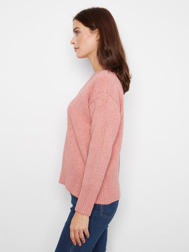 Experience warmth with this pink sweater's long sleeves, perfect for layering during cooler seasons while maintaining elegance. By Charlie B.