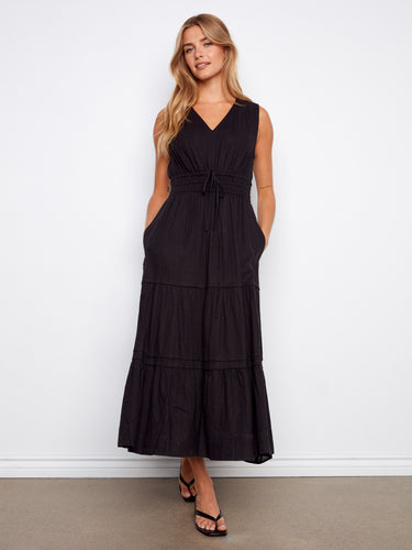 Chic black maxi dress featuring convenient slash pockets and a tiered silhouette, offering both style and functionality by Charlie B.