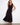 Black sleeveless dress with a flattering V-neckline and elegant tiered design, perfect for any occasion by Charlie B.