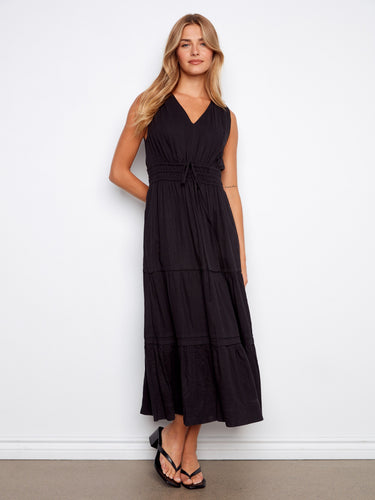 Elegant maxi length black dress showcasing a graceful tiered design that adds movement and charm to the outfit by Charlie B.