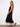 Sophisticated black dress with V-neckline and flowing tiers, designed for effortless elegance in every step by Charlie B.