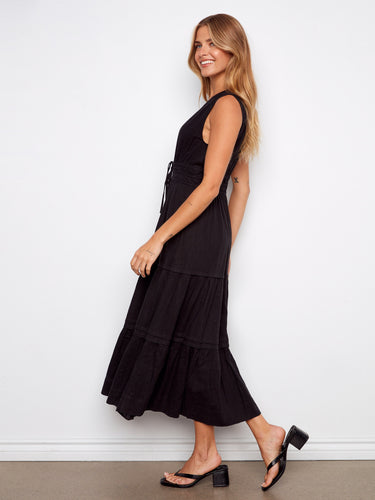 Sophisticated black dress with V-neckline and flowing tiers, designed for effortless elegance in every step by Charlie B.