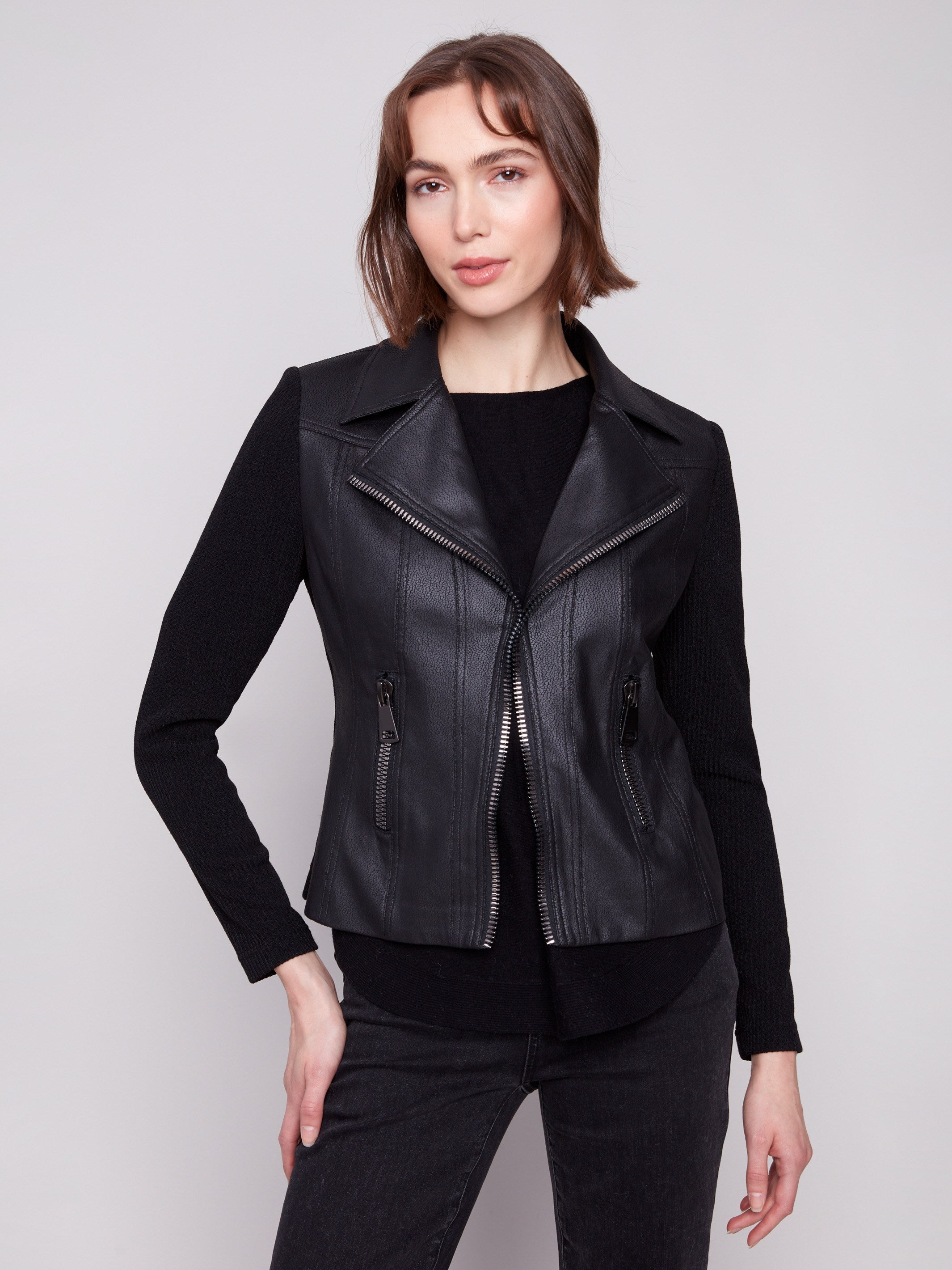 Fashionable black jacket showcasing faux pockets with zippers, adding flair by Charlie B.