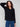 Stylish black sweater featuring a V-neckline and elegant button accents on the sleeves, perfect for any occasion by Charlie B.