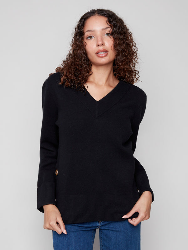 Elegant black V-neck sweater with buttons at the sides, adding a unique flair to this classic piece by Charlie B.