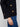 Black sweater showcasing wide cuffs and side buttons, creating a refined look for versatile styling options by Charlie B.