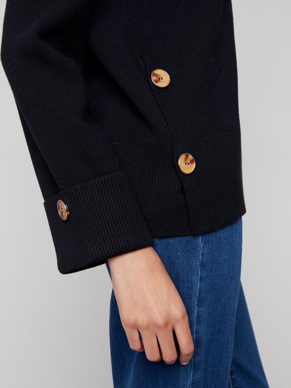 Black sweater showcasing wide cuffs and side buttons, creating a refined look for versatile styling options by Charlie B.