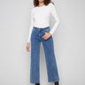 These blue jeans feature a long length and embossed heart pattern, offering a chic style by Charlie B.