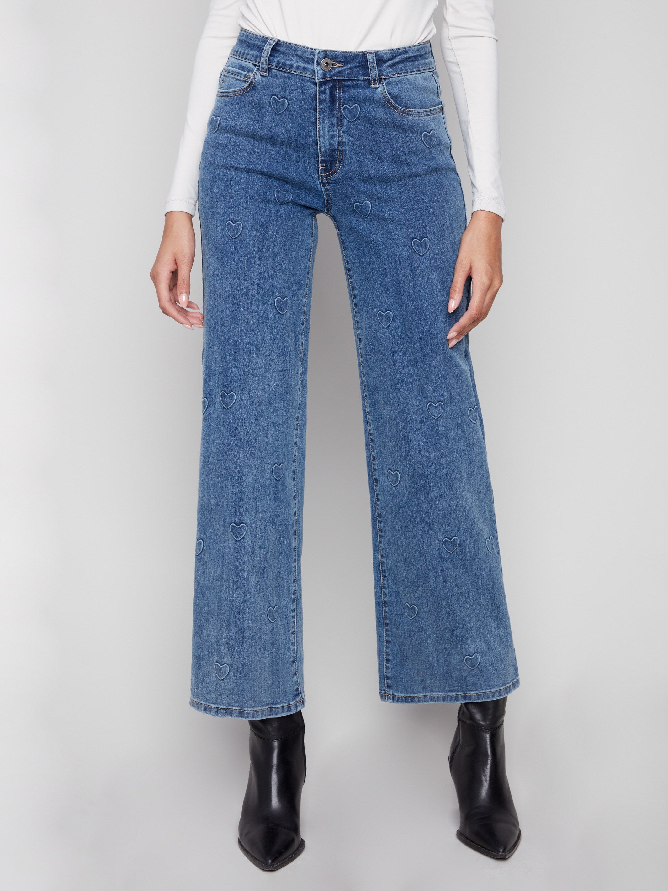 Showcasing a five-pocket design, these blue jeans with heart accents provide both functionality and flair by Charlie B.