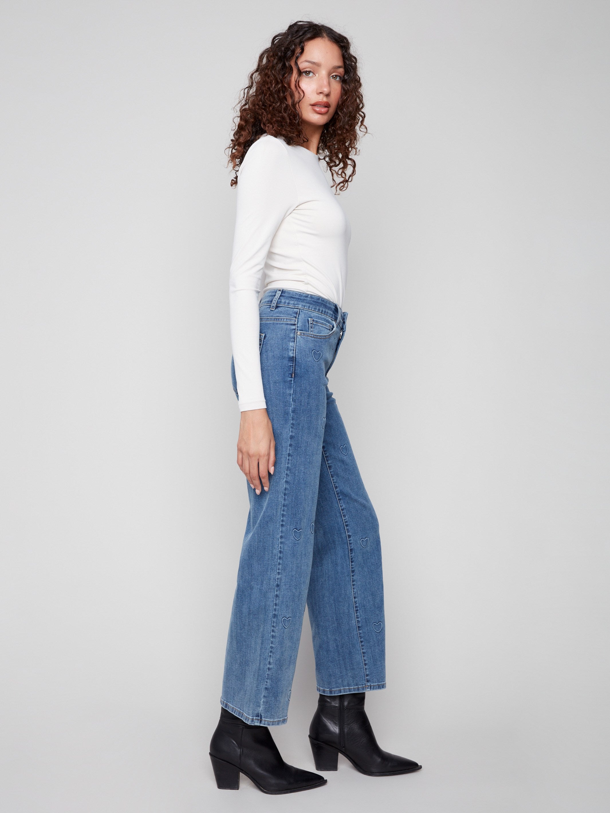 With a regular rise fit, these stylish jeans are adorned with an embossed heart pattern for added charm by Charlie B.