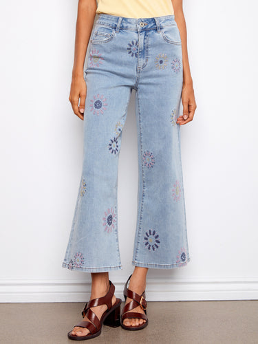 Stylish cropped length denim jeans with intricate pixelated flower embroidery. Perfect for any occasion. By Charlie B.