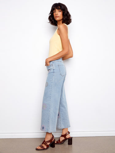 These five pocket design jeans offer both style and functionality, accented by pixelated flower details. By Charlie B.