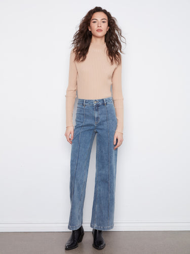 These jeans feature an extra-wide leg design, offering a trendy and comfortable fit by Charlie B.