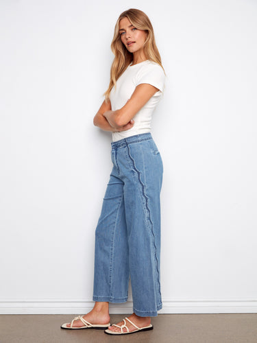 These stylish blue wide-leg jeans feature scalloped edges and convenient slash pockets, offering both fashion and function by Charlie B.
