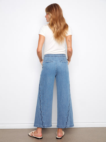Regular-rise blue jeans with a chic wide leg design, enhanced by intricate scalloped edges for added style by Charlie B.