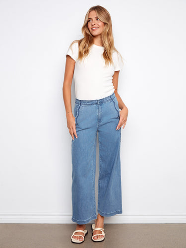 Chic blue wide-leg pants featuring slash pockets and stylish scalloped edges, perfect for versatile wear by Charlie B.