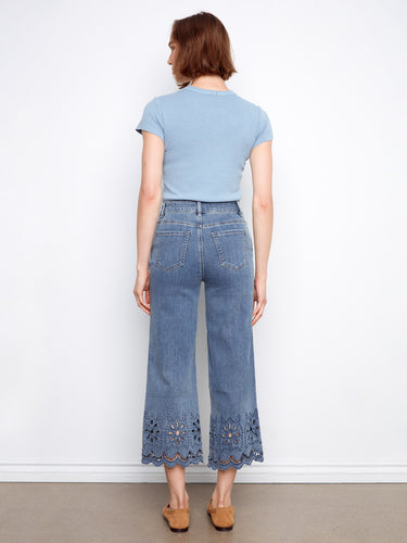 Wide leg denim pants with intricate eyelet hem, blending casual elegance and functionality effortlessly. Created by Charlie B.