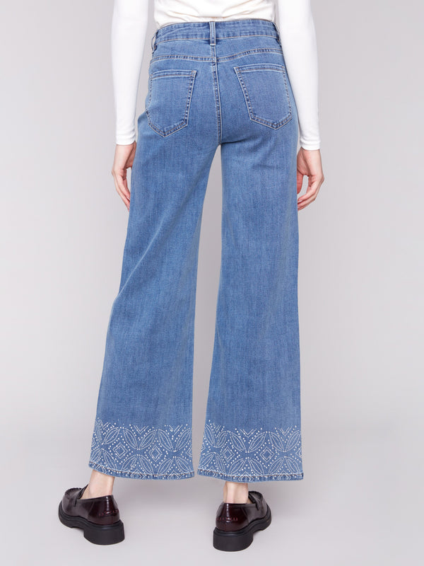 Wide-leg jeans in medium blue, showcasing a five-pocket design and crafted from durable stretch denim by Charlie B.