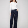 Deep blue jeans with a long length and floral sequin details, offering a chic look by Charlie B.