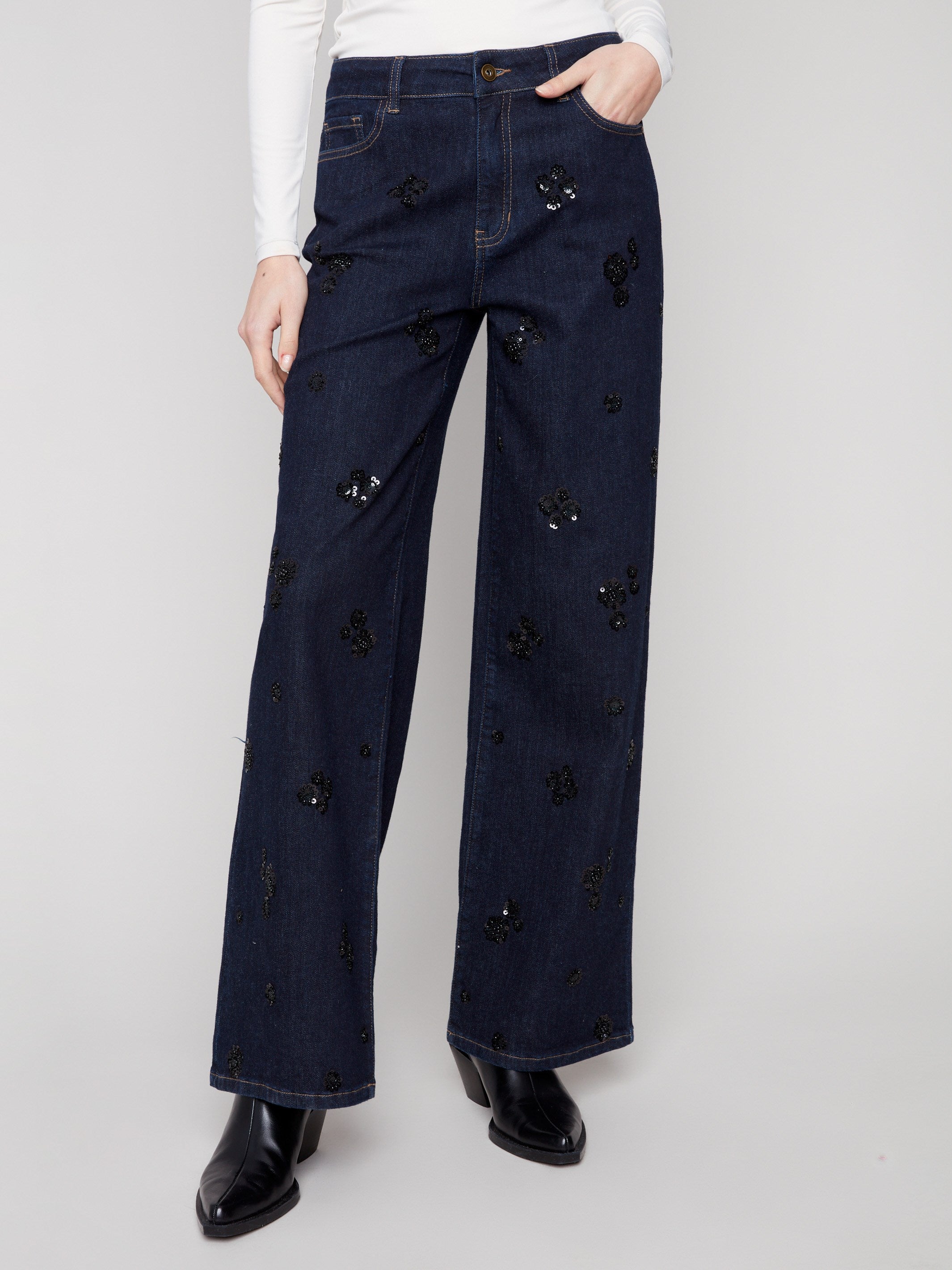 These stretch denim jeans showcase elegant floral embroidery and a modern wide-leg cut by Charlie B.