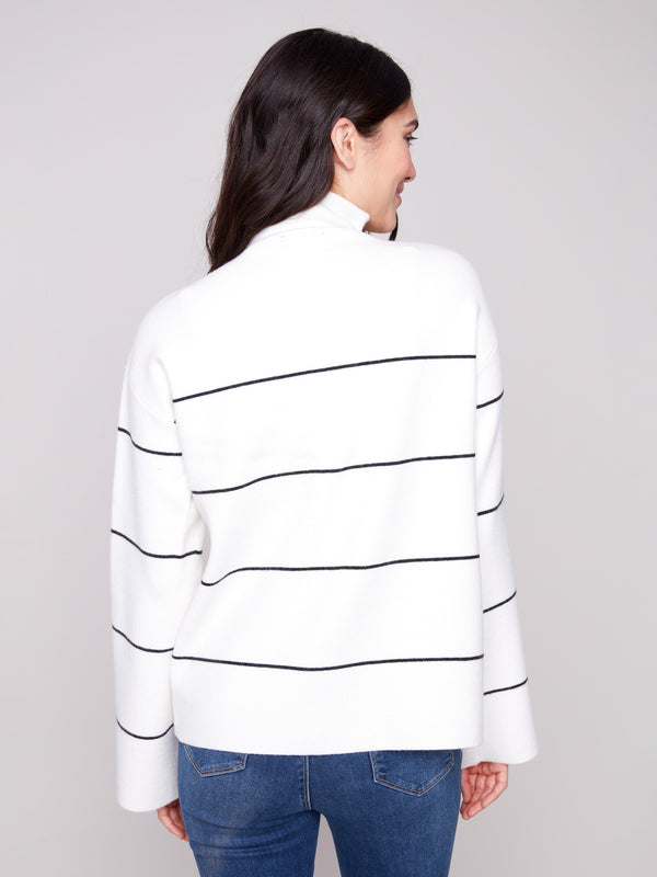 Ecru sweater showcasing a relaxed fit with bold black stripes for a modern touch by Charlie B.